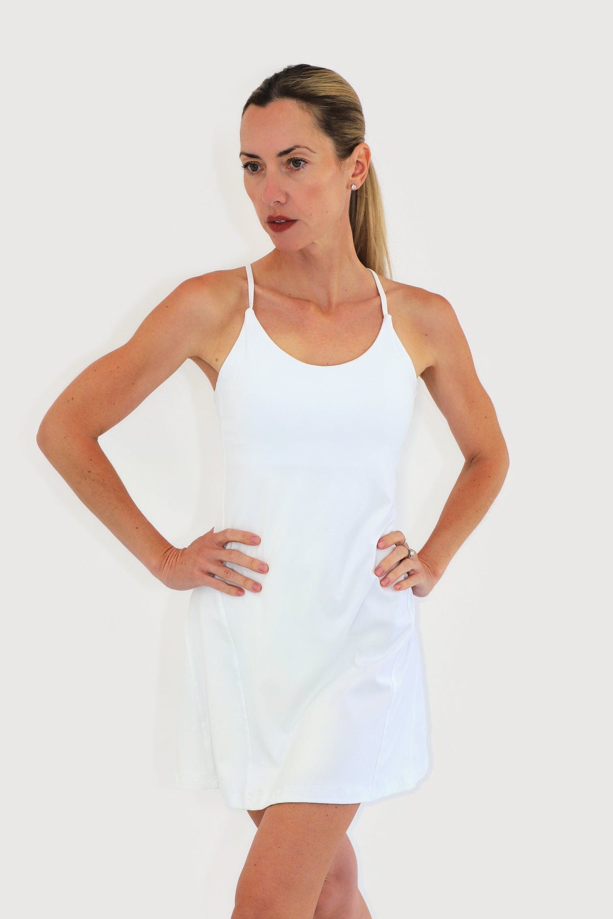 Pacific Dress in White, front view: spaghetti straps, scoop neckline and A-line skirt with built-in shorts