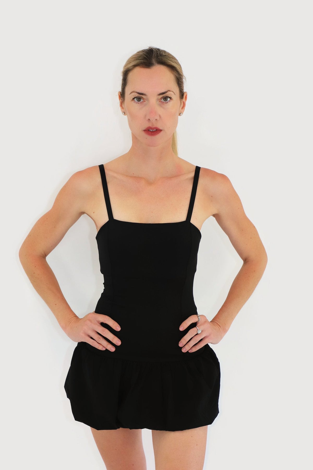 Shore Dress in Black, front view with thin straps and bubble-hem skirt